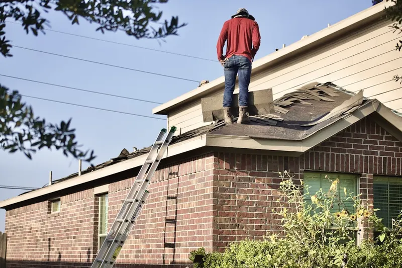 Professional roofer working on a residential roof in Newark Oaks